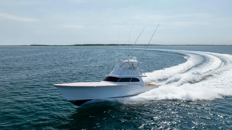 Double B Yacht Photos Pics Custom Carolina Taylor Made 2000 boat cruising swiftly on open water.