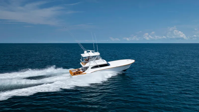 Double B Yacht Photos Pics Custom Carolina Taylor Made 2000 yacht cruising on open ocean under clear blue sky.