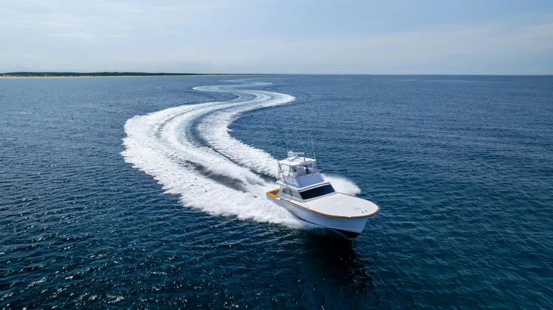 Double B Yacht Photos Pics Custom Carolina Taylor Made 2000 boat cruising on open ocean, leaving a curved wake.