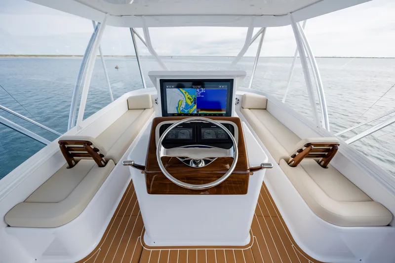 Double B Yacht Photos Pics Helm of 2000 Custom Carolina Taylor Made boat with navigation screen and wooden steering wheel.