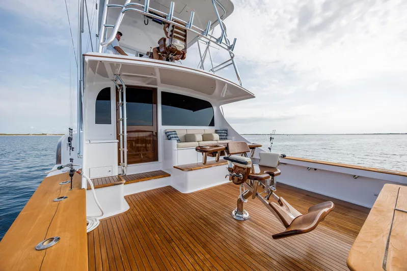 Double B Yacht Photos Pics Custom Carolina Taylor Made 2000 yacht with wooden deck and fishing chairs on open water.