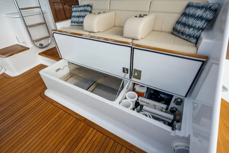 Double B Yacht Photos Pics Luxury boat interior with storage compartments, teak flooring, and cushioned seating. Custom Carolina Taylor Made 2000.