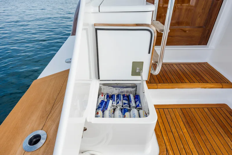 Double B Yacht Photos Pics Custom Carolina Taylor Made 2000 boat with built-in cooler filled with drinks, docked on water.