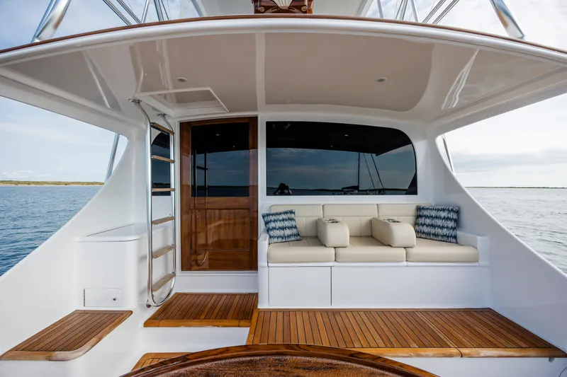 Double B Yacht Photos Pics Luxurious 2000 Custom Carolina Taylor Made yacht deck with seating, wooden accents, and ocean view.