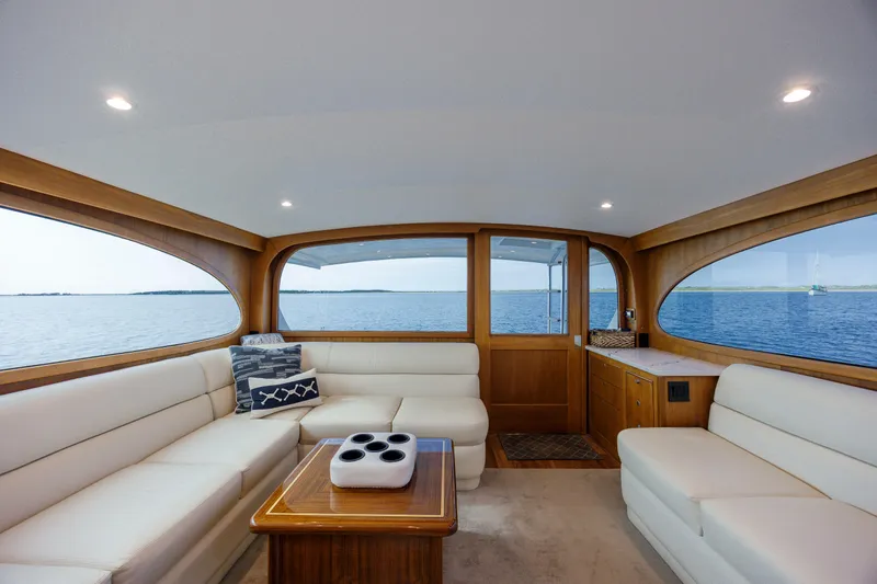 Double B Yacht Photos Pics Luxurious interior of 2000 Custom Carolina Taylor Made yacht with white seating and ocean view.