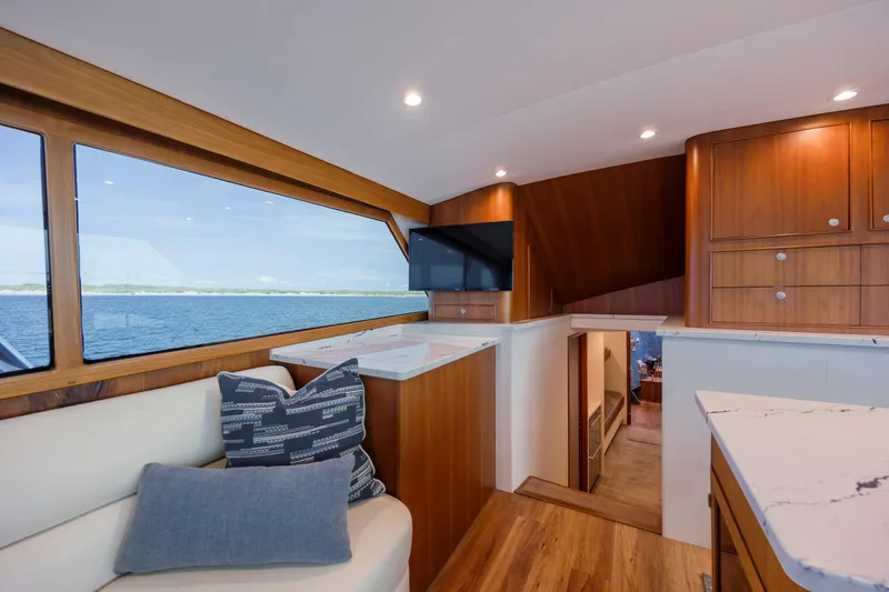 Double B Yacht Photos Pics Luxurious interior of 2000 Custom Carolina Taylor Made yacht with wood finishes and ocean view.