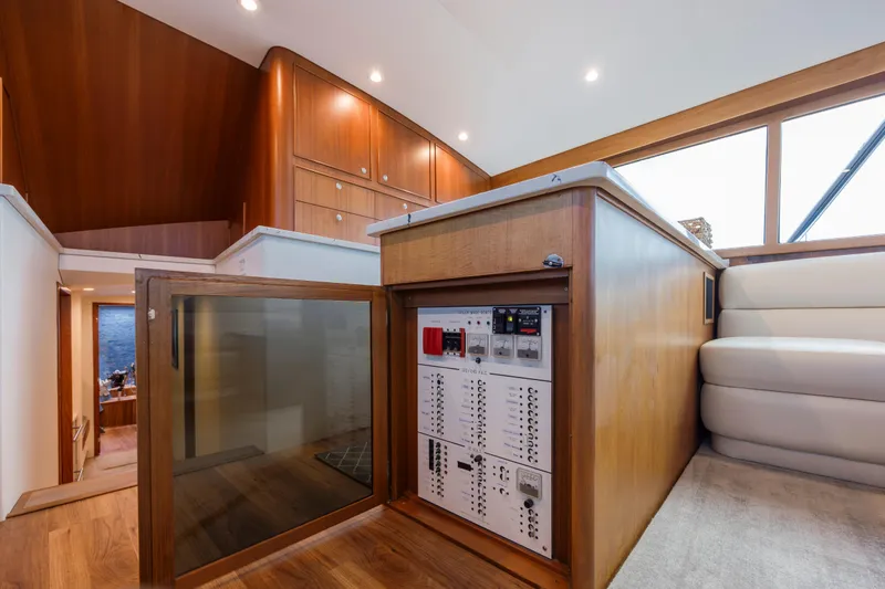 Double B Yacht Photos Pics Interior of 2000 Custom Carolina Taylor Made yacht with control panel and wooden cabinetry.