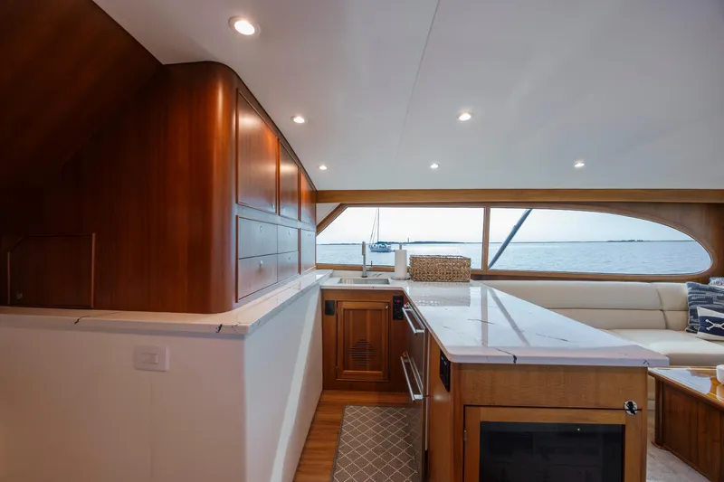 Double B Yacht Photos Pics Luxurious interior of 2000 Custom Carolina Taylor Made yacht with elegant wood cabinetry and ocean view.