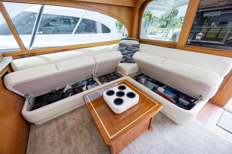 Double B Yacht Photos Pics Luxurious 2000 Custom Carolina Taylor Made yacht interior with white seating and storage compartments.