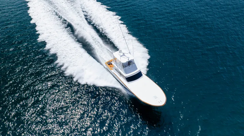 Double B Yacht Photos Pics Custom Carolina Taylor Made 2000 boat cruising on open blue water, leaving a white wake.