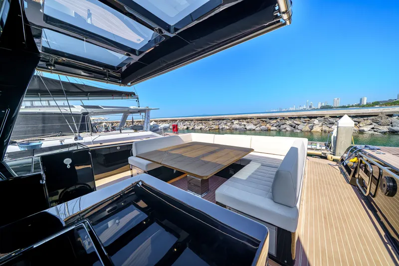 Yacht Photos Pics Luxurious 2024 Pardo Yachts P50 with elegant outdoor seating and scenic marina view.