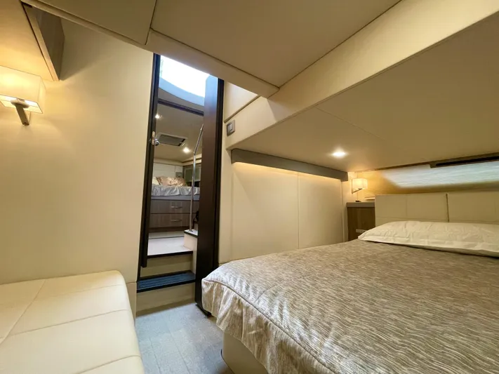 About Time Yacht Photos Pics Luxurious interior of 2022 Regal 42 Grande Coupe yacht bedroom with modern design.
