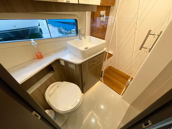 About Time Yacht Photos Pics Modern bathroom in 2022 Regal 42 Grande Coupe yacht with sink, toilet, and shower.