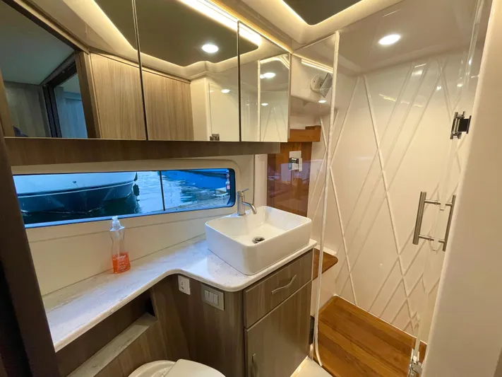 About Time Yacht Photos Pics Luxurious bathroom in 2022 Regal 42 Grande Coupe yacht with modern fixtures and elegant design.