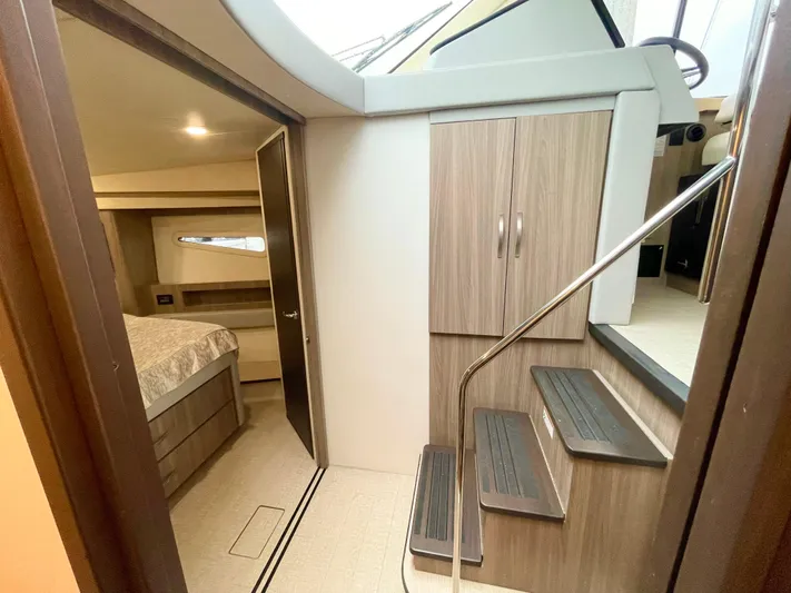 About Time Yacht Photos Pics 2022 Regal 42 Grande Coupe interior with stairs and bedroom view.