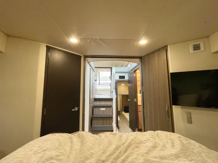 About Time Yacht Photos Pics Interior view of 2022 Regal 42 Grande Coupe yacht, featuring stairs and modern design elements.