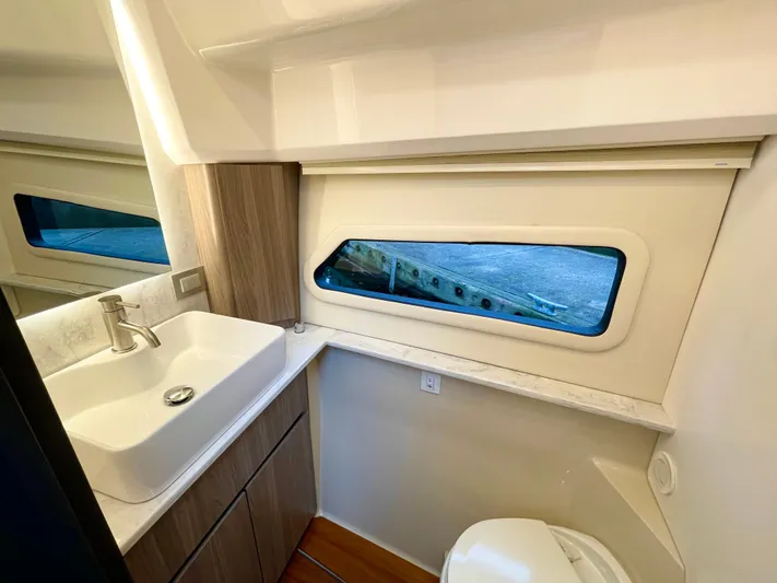 About Time Yacht Photos Pics Modern bathroom interior of 2022 Regal 42 Grande Coupe yacht, featuring sleek sink and window.