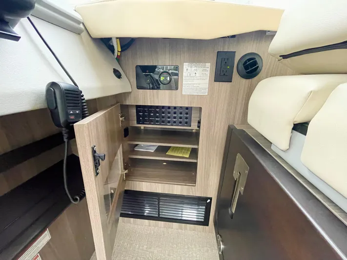 About Time Yacht Photos Pics Interior of 2022 Regal 42 Grande Coupe showing storage and control panel.