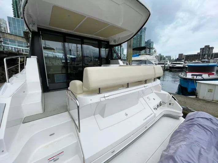 About Time Yacht Photos Pics 2022 Regal 42 Grande Coupe yacht docked at marina, showcasing sleek design and spacious seating.