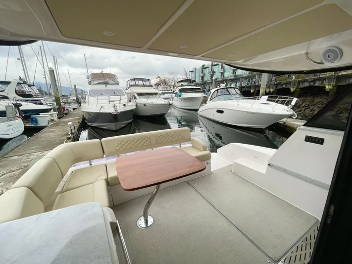 About Time Yacht Photos Pics 2022 Regal 42 Grande Coupe yacht interior with docked boats in marina.