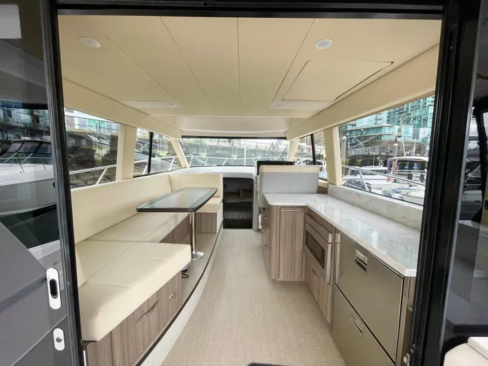 About Time Yacht Photos Pics Interior of 2022 Regal 42 Grande Coupe yacht, featuring modern seating and cabinetry.