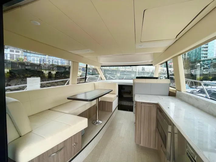 About Time Yacht Photos Pics Interior of 2022 Regal 42 Grande Coupe yacht with modern seating and kitchen area.