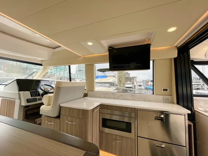 About Time Yacht Photos Pics Interior of 2022 Regal 42 Grande Coupe yacht with modern kitchen and helm.