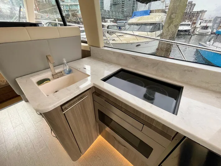 About Time Yacht Photos Pics Modern kitchen in 2022 Regal 42 Grande Coupe yacht with sleek countertops and appliances.