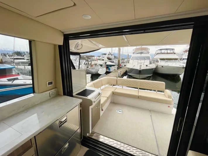 About Time Yacht Photos Pics 2022 Regal 42 Grande Coupe yacht interior with open deck view at marina.