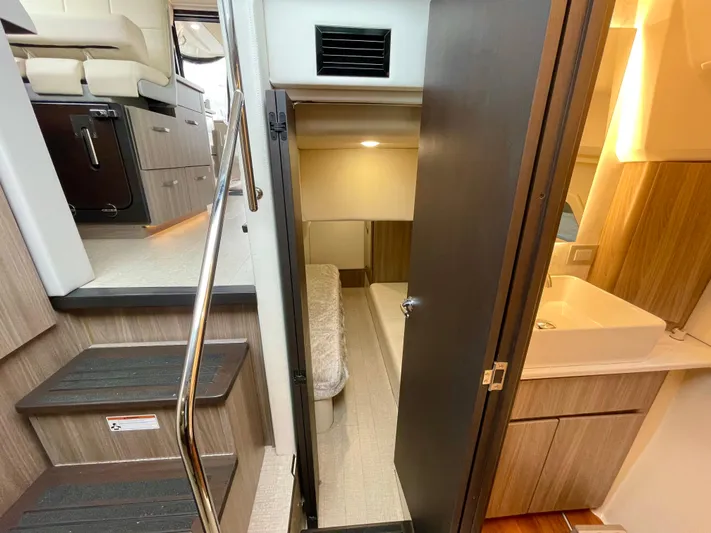 About Time Yacht Photos Pics Interior of 2022 Regal 42 Grande Coupe yacht, featuring stairs, cabin, and bathroom.