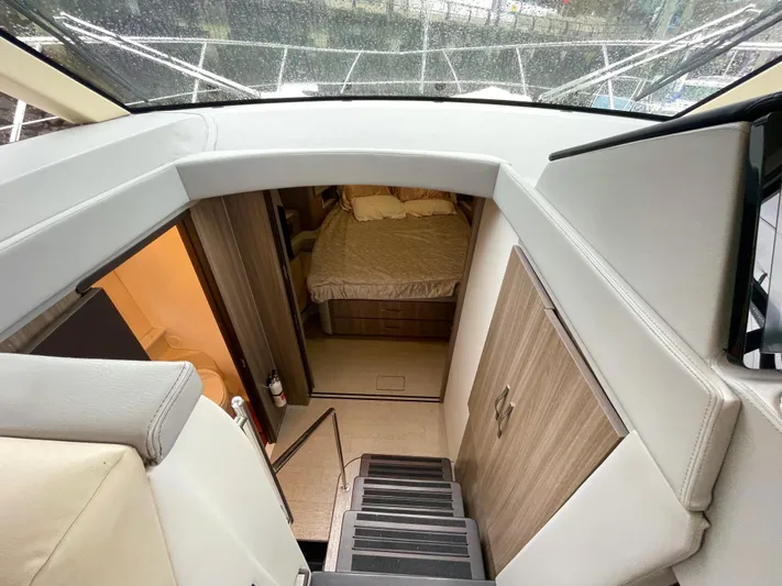 About Time Yacht Photos Pics 2022 Regal 42 Grande Coupe interior with stairs leading to a cozy bedroom.