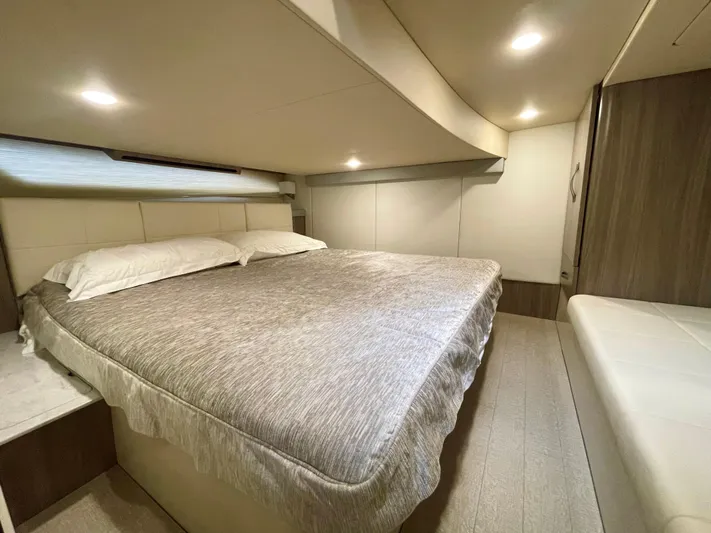 About Time Yacht Photos Pics 2022 Regal 42 Grande Coupe bedroom with cozy bed and modern lighting.