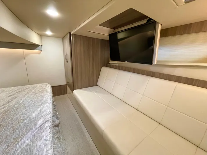 About Time Yacht Photos Pics Interior of 2022 Regal 42 Grande Coupe with modern seating and wall-mounted TV.