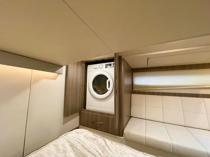 About Time Yacht Photos Pics Laundry area in 2022 Regal 42 Grande Coupe yacht with modern washer.