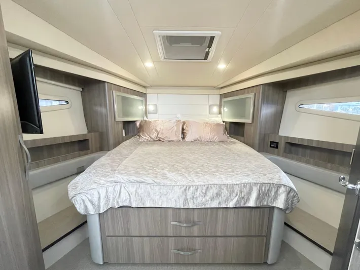 About Time Yacht Photos Pics Luxurious bedroom interior of 2022 Regal 42 Grande Coupe yacht with modern design.