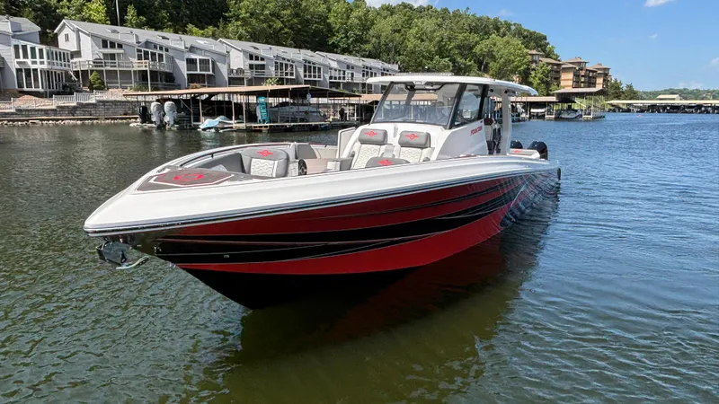  Yacht Photos Pics 2024 Fountain 43 SCX boat on a lake near waterfront homes.