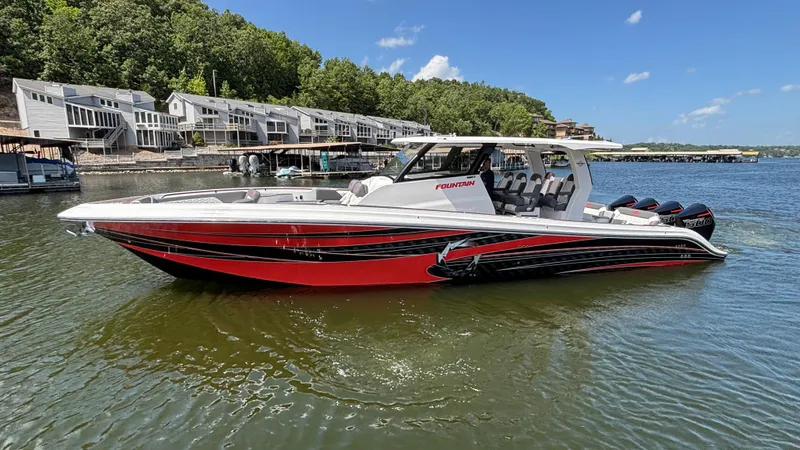  Yacht Photos Pics 2024 Fountain 43 SCX boat on a lake, with modern design and vibrant red accents.