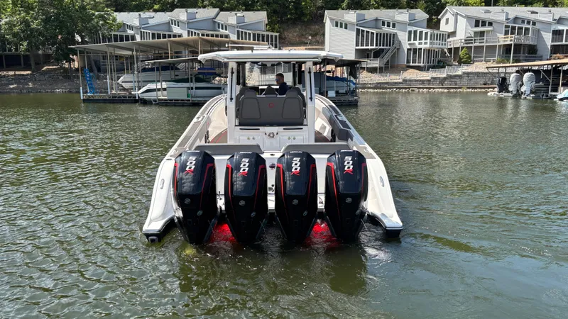  Yacht Photos Pics 2024 Fountain 43 SCX boat with four powerful outboard motors on a calm lake.