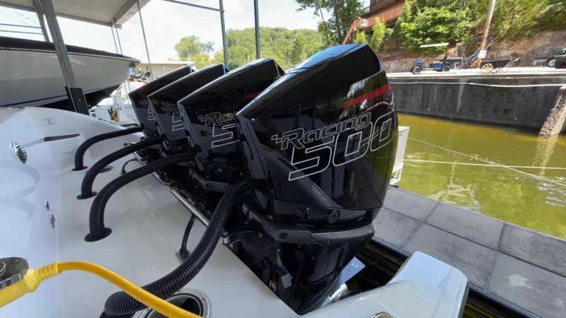  Yacht Photos Pics 2024 Fountain 43 SCX boat with powerful Racing 500 engines docked by the water.