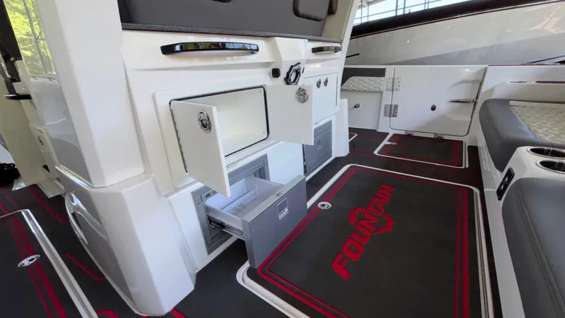  Yacht Photos Pics 2024 Fountain 43 SCX boat interior with open storage compartments and branded flooring.