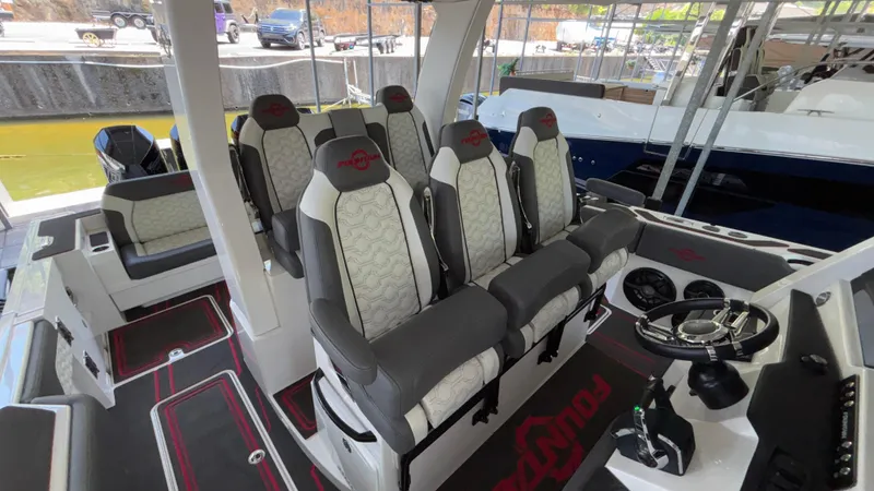  Yacht Photos Pics 2024 Fountain 43 SCX boat interior with luxurious seating and modern steering console.