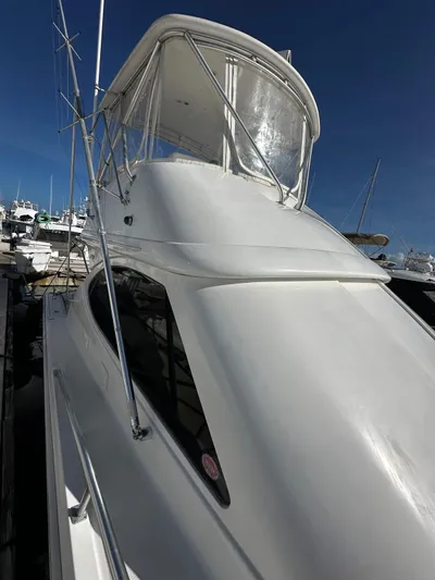  Yacht Photos Pics 2006 Tiara Yachts 3900 Convertible, sleek white exterior, docked under clear blue sky.