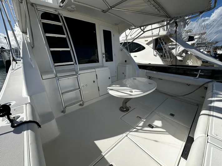  Yacht Photos Pics 2006 Tiara Yachts 3900 Convertible, spacious deck with seating and table, docked at marina.