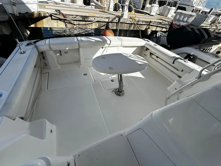  Yacht Photos Pics 2006 Tiara Yachts 3900 Convertible boat deck with seating and table, docked at marina.