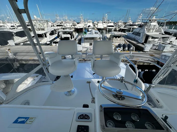  Yacht Photos Pics Tiara Yachts 2006 3900 Convertible helm with marina view, featuring dual captain chairs.
