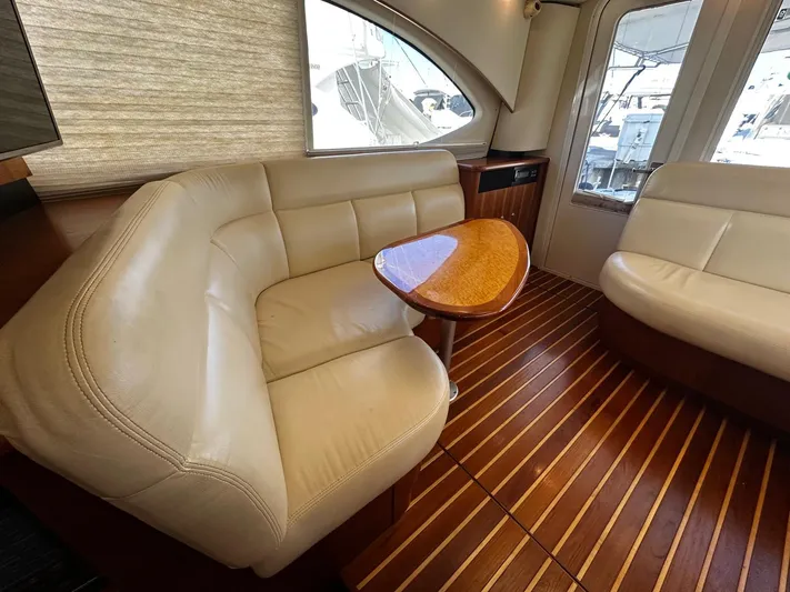  Yacht Photos Pics Luxurious 2006 Tiara Yachts 3900 Convertible interior with leather seating and wooden flooring.