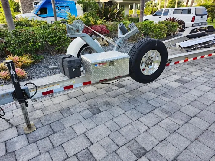 Cay Day Yacht Photos Pics Trailer for 2017 Pursuit 325 OS boat on paved driveway.