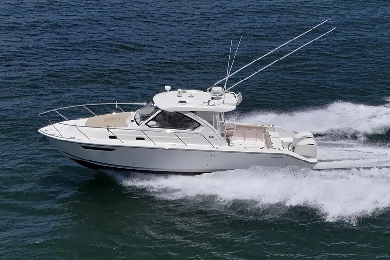 Cay Day Yacht Photos Pics 2017 Pursuit 325 OS boat cruising on open water, side view.