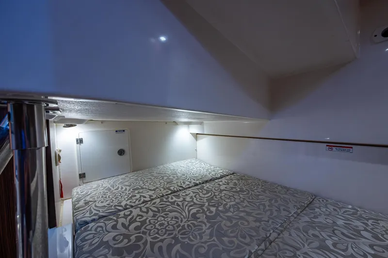 Cay Day Yacht Photos Pics 2017 Pursuit 325 OS cabin interior with patterned bedding and ambient lighting.