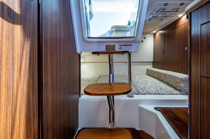 Cay Day Yacht Photos Pics Interior of 2017 Pursuit 325 OS boat with wooden steps and cozy cabin.